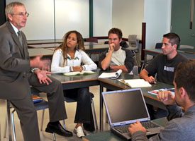 Teacher talking to small group of students.