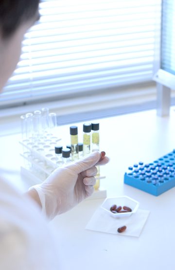 Photo of researcher holding sample vials.