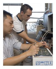 two technicians working on machines