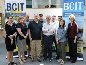 Group of people posing in front of BCIT banners