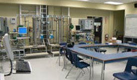 classroom with pipes & gauges along far wall.
