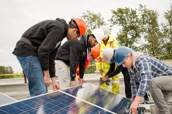 students working on solar panels