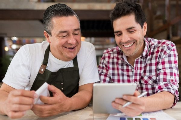 Men doing the books at a restaurant