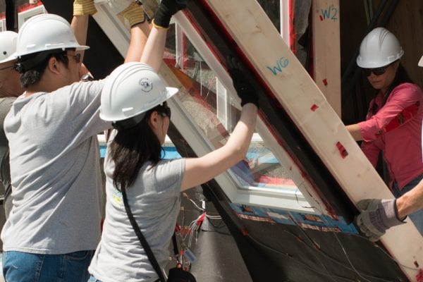 Building Science students holding a wall