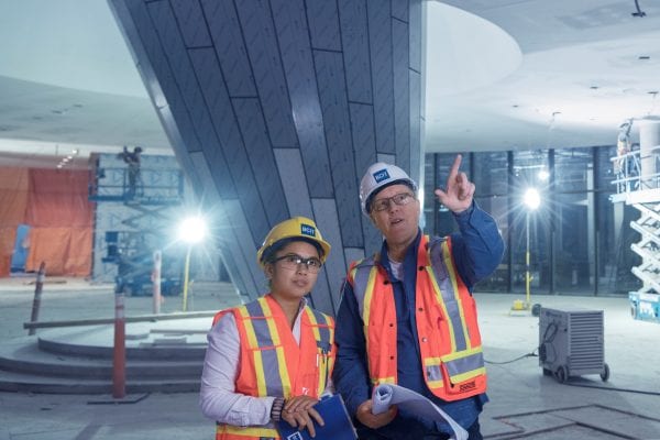 Instructor and student wearing hard hats and safety vests