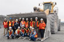 students in front of a mining vehicle
