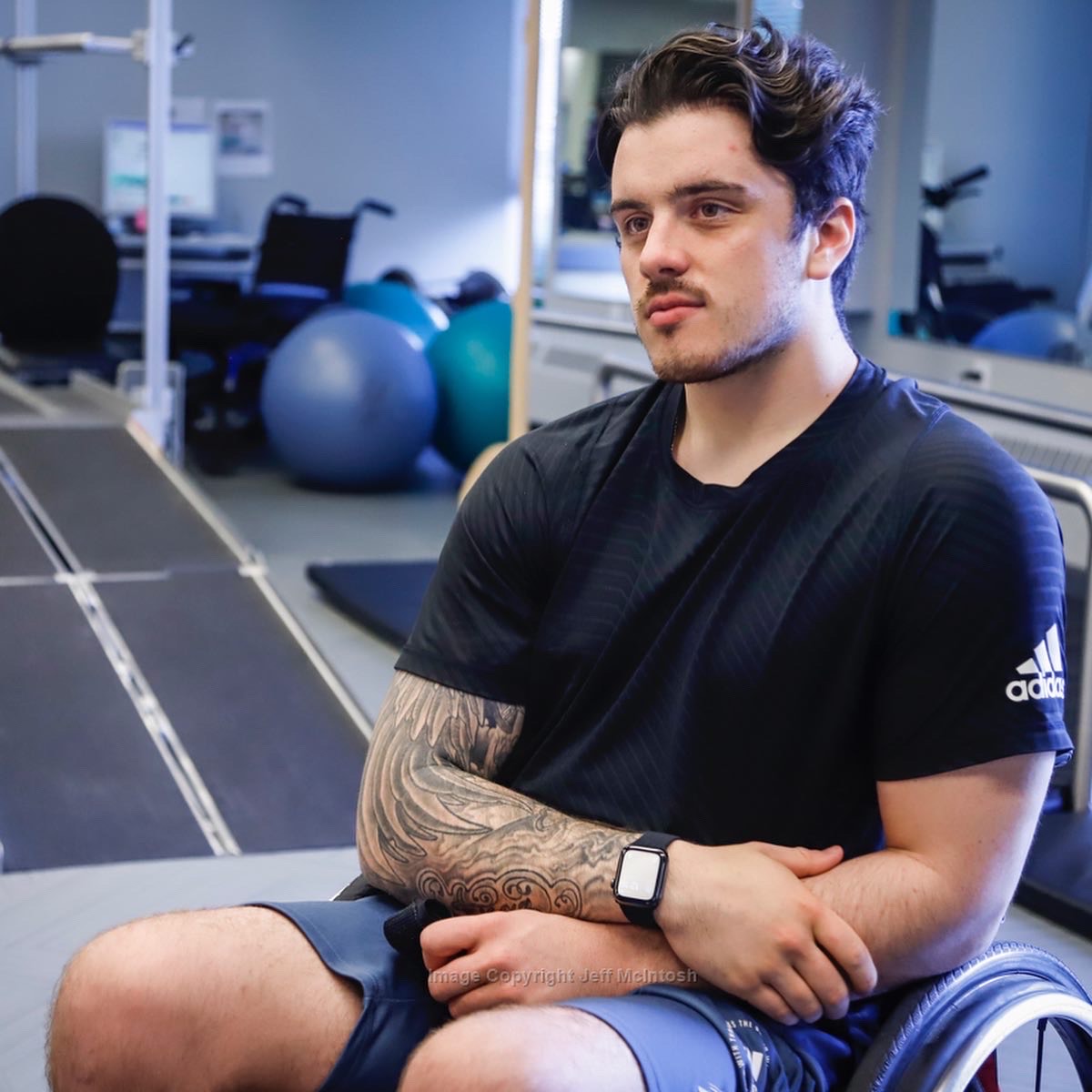 Ryan in a wheel chair at a gym