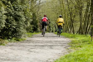 two bikers on a trail in the woods