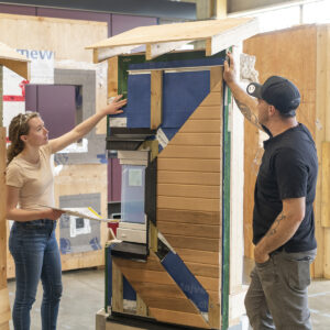 BCIT Students at the Zero Energy/Emissions Building Learning Centre eexamining a real wall assemby that would meet the passive house standard.