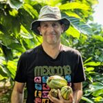 David Leventhal, a male in black tshirt, bucket hat, and fruits in his hand