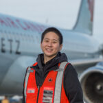 Jenny in the airport runway in a safety vest