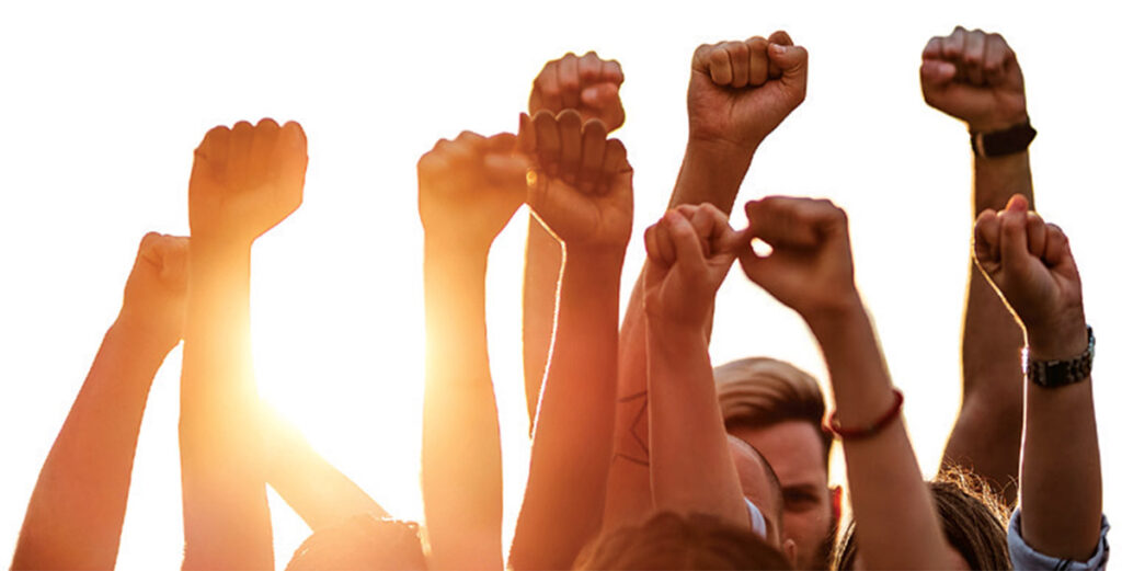 multiple and diverse arms raised in the air