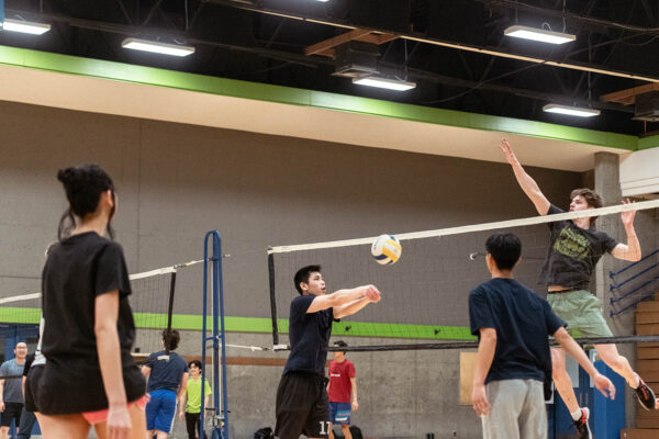 Mixed groups of students playing intramural volleyball in the BCIT gym