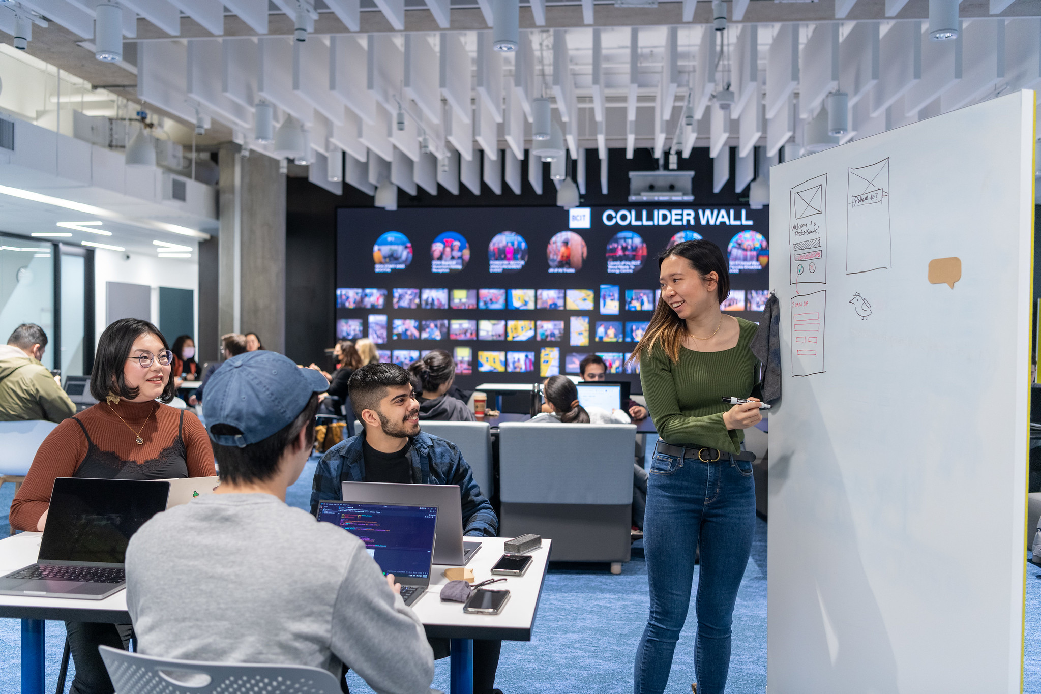 Three students in Tech Collider building doing a group project together.