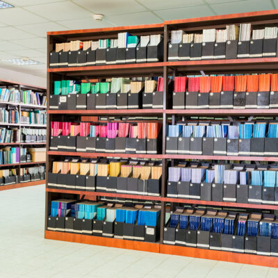 Shelves with old books and journals in scientific library.