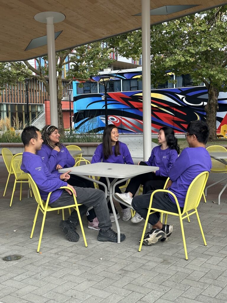 Students sitting around a table outdoors