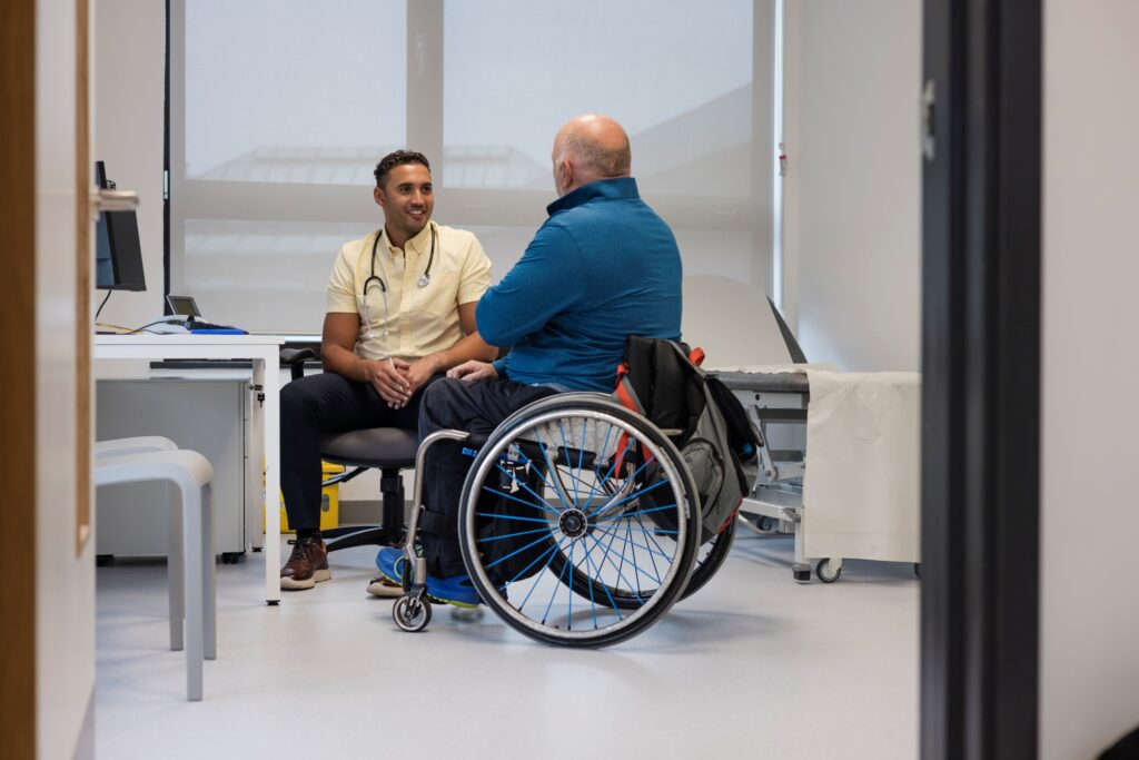 client in wheelchair meeting with health care provider in an office