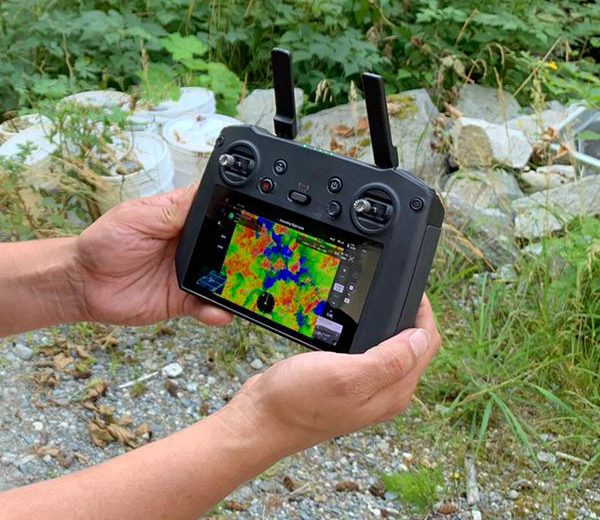 close-up of drone controller screen showing thermal image