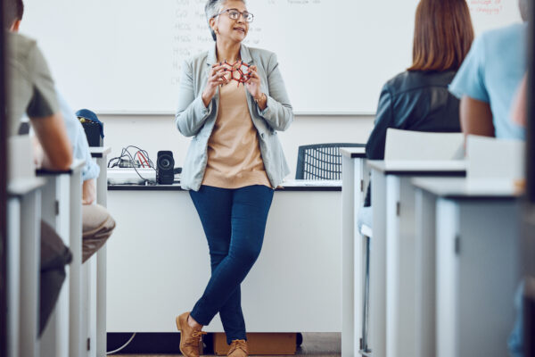 Professor teaching in a classroom setting filled with students